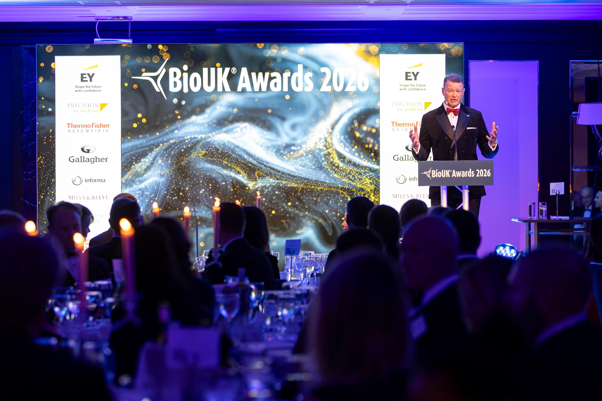 BioUK Awards presenter speaking at lectern at the 2026 award ceremony
