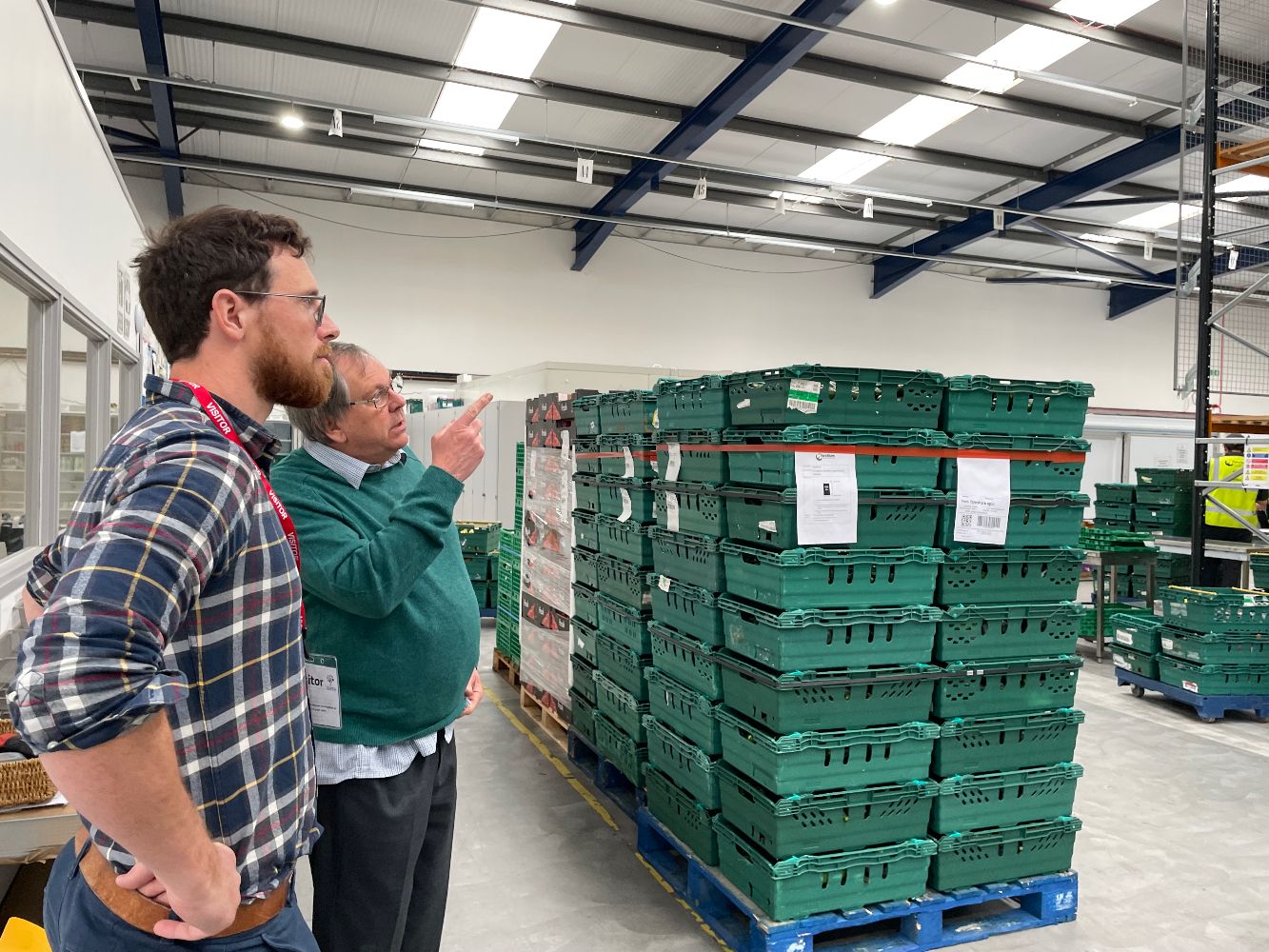 IDRM Deputy Building and Facilities Manager, Andrew Brogden, talks to a SOFEA vounteer at a community larder site.