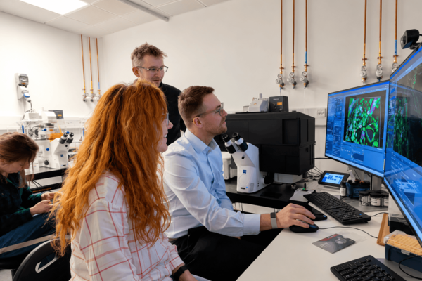 Scientists looking at a screen 